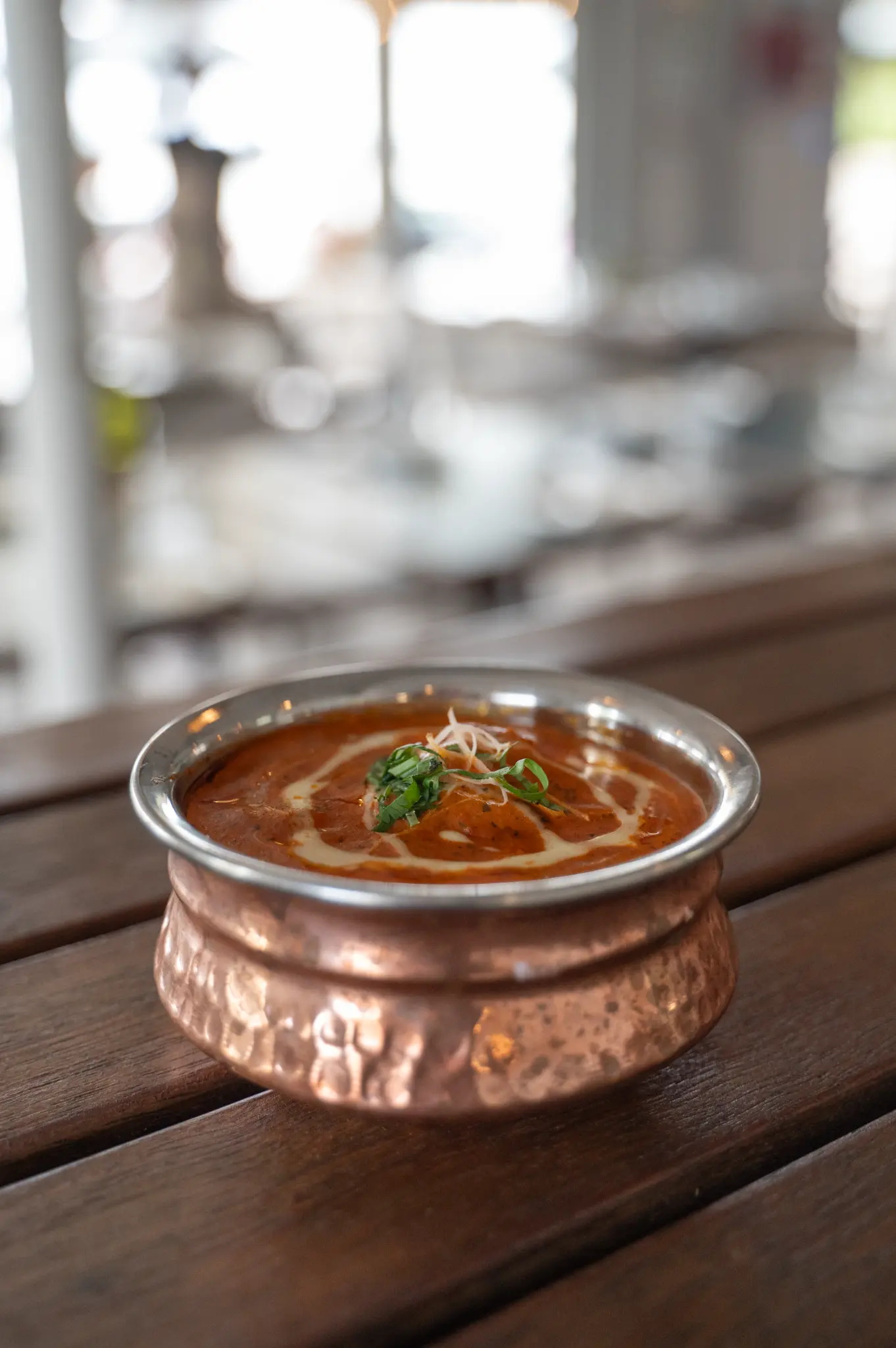 Butter chicken in a copper bowl at Bombay at Bucklands